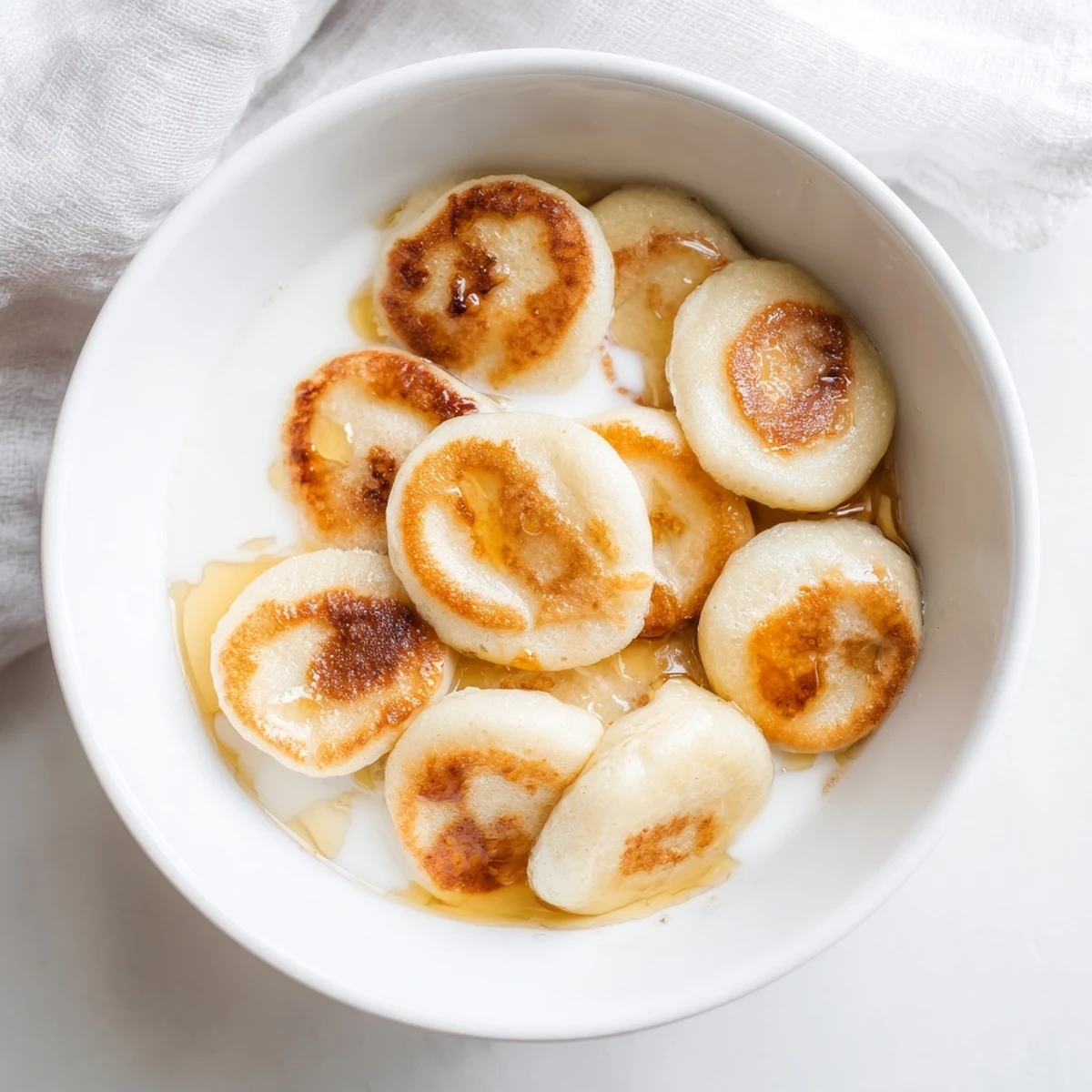 Golden-brown, fluffy pancake cereal sprinkled with powdered sugar, ready for a delicious breakfast.