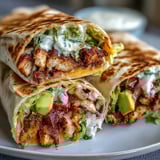 Crispy Chicken Bacon Wrap halved to show melted cheese and fresh lettuce.