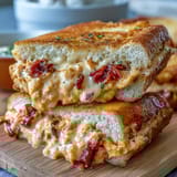 Creamy pimento cheese finger sandwiches with sharp cheddar and pimentos on white bread, perfect for Derby parties.