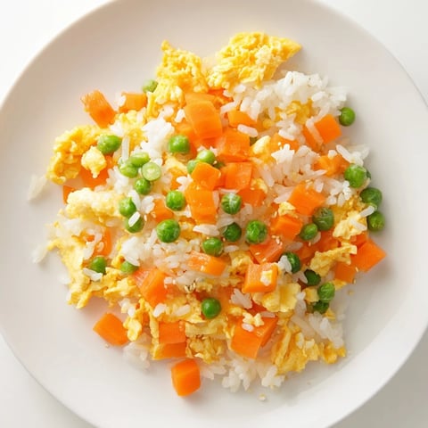 Golden, fluffy Egg Fried Rice with colorful vegetables, perfect for a quick dinner.