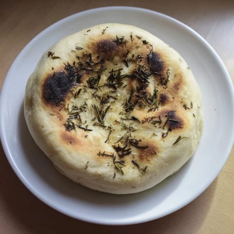 Fresh, herbal rosemary perfumes this Quick Homemade Flatbread, lightly crisp from the skillet.