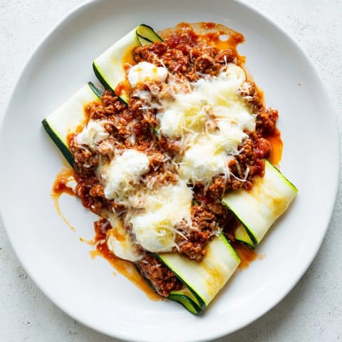 This zucchini lasagna skillet shows off layers of zucchini, meat sauce, and melted cheese, ready to be devoured.