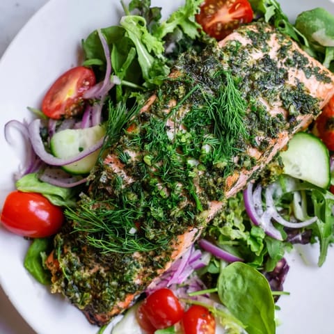 Warm, herb-baked salmon beautifully complements a fresh green salad in this Herb-Crusted Salmon Salad.