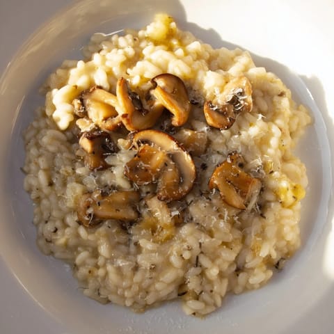 Creamy, golden risotto with mushrooms showcasing tender Arborio rice and savory flavors.