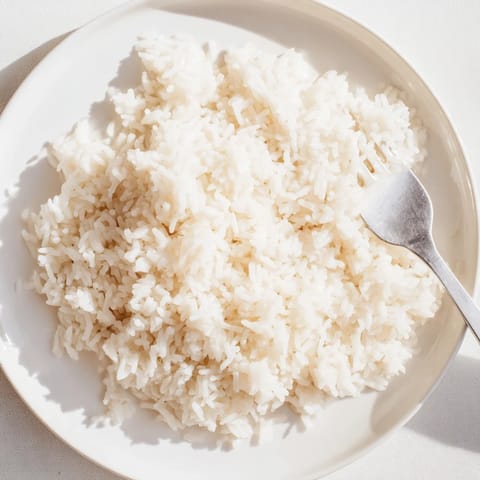Aromatic Coconut Jasmine Rice glistening with coconut milk, perfect with a flavorful curry.