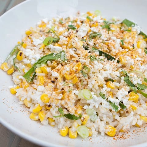 A bowl of flavorful Mexican Street Corn Rice with visible cilantro, perfect for a vibrant side.