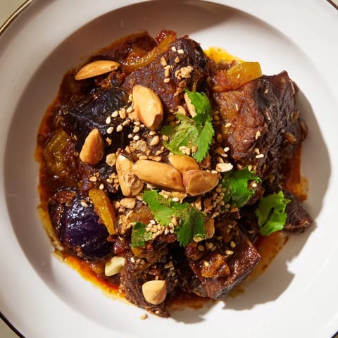 Tender lamb in Moroccan Tagine, slow-cooked with sweet prunes and crunchy toasted almonds.