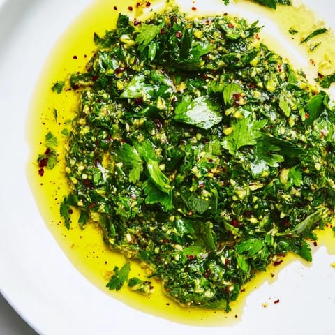 Vibrant Moroccan Chermoula Marinade ready to coat fresh fish, showcasing bright herbs and spices for rich flavors.