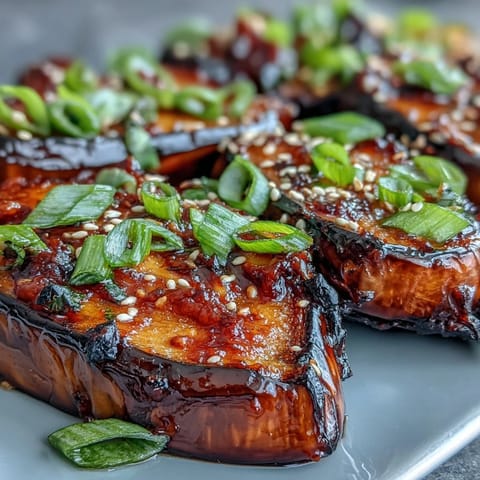 Tender miso glazed eggplant halves, caramelized and topped with sesame seeds and scallions.