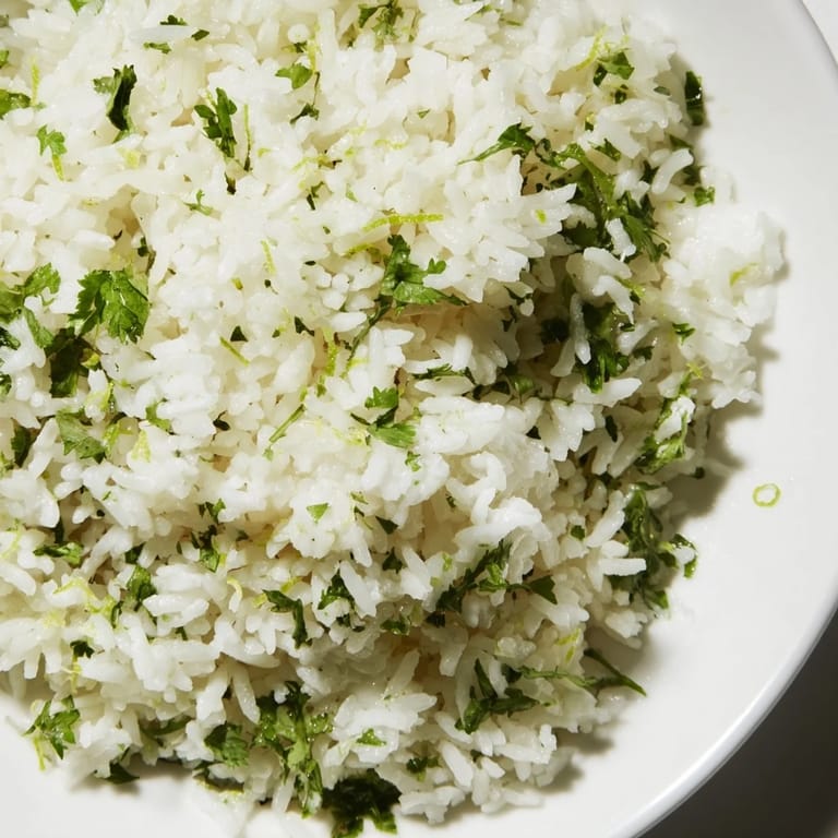 Steaming bowl of Cilantro Lime Rice, ready to serve with grilled chicken or tacos, smells amazing.