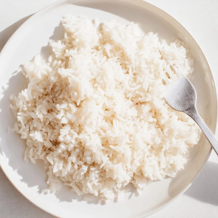 Aromatic Coconut Jasmine Rice glistening with coconut milk, perfect with a flavorful curry.