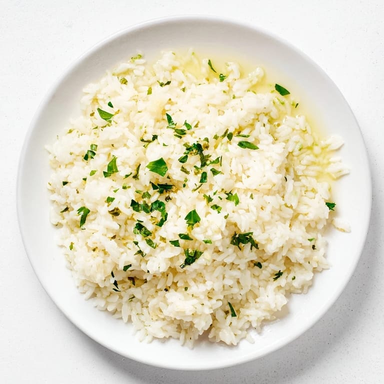 Close-up shot shows flavorful Garlic Butter Rice, aromatic, buttery and cooked in chicken broth.