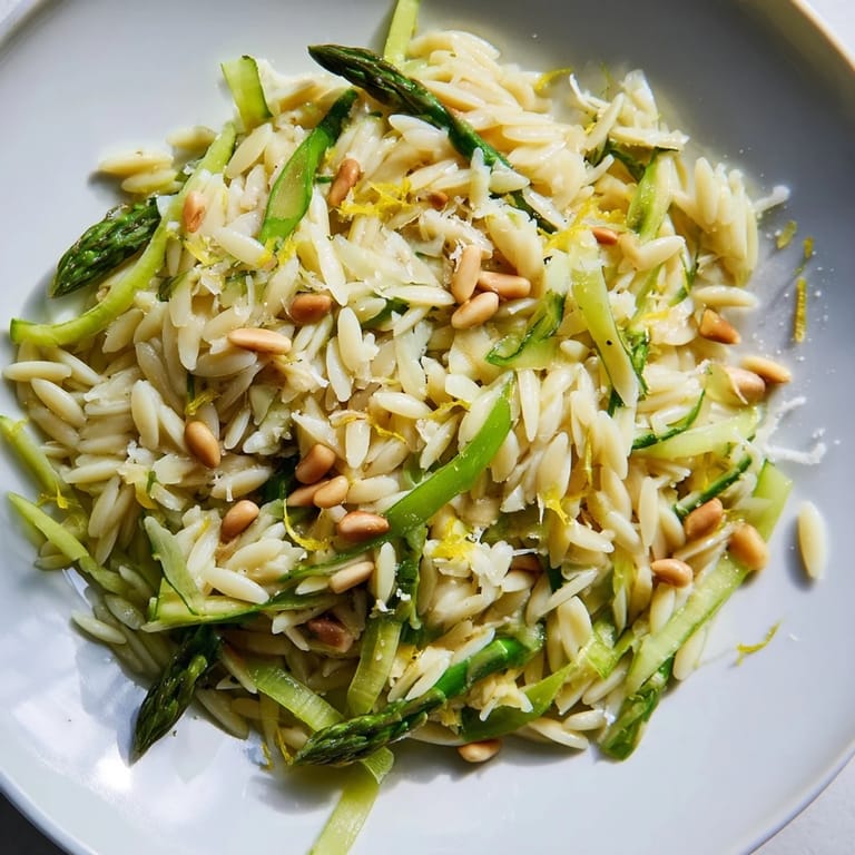For a visually impaired user, imagine the Asparagus Lemon Orzo Salad: green asparagus ribbons, golden toasted pine nuts, and crumbly Parmesan cheese mixed into a light, citrusy pasta salad.