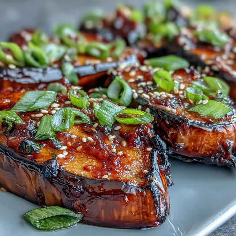 Tender miso glazed eggplant halves, caramelized and topped with sesame seeds and scallions.